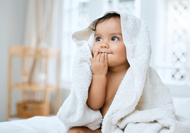 I taste so fresh Shot of an adorable baby covered in a towel after bath time