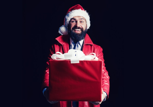 Photo i want to give you your christmas present surprised santa with christmas gift