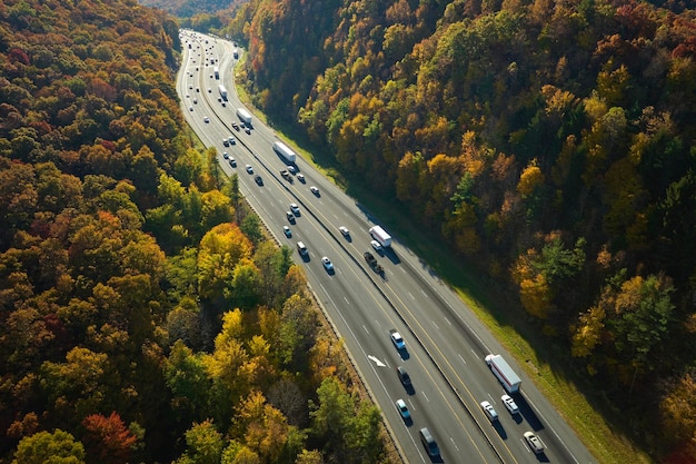 I40 freeway in North Carolina leading to Asheville through Appalachian mountains in golden fall with fast moving trucks and cars Interstate transportation concept