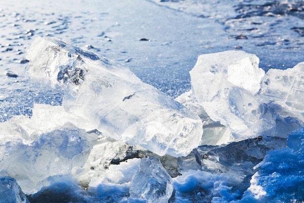 Ice blocks on the edge of icehole in frozen lake