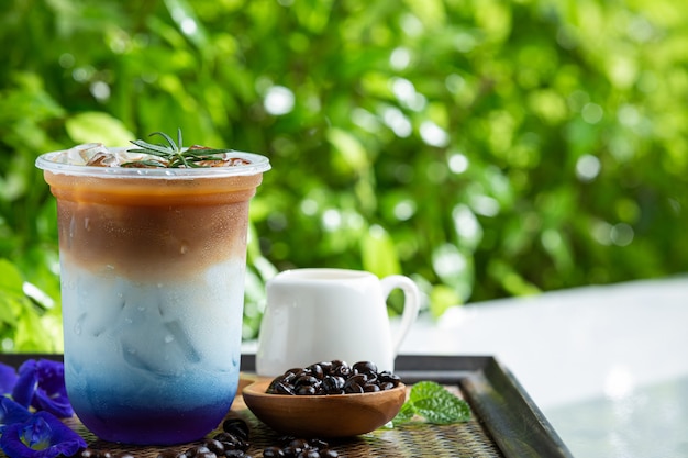 Ice butterfly pea latte on wooden surface