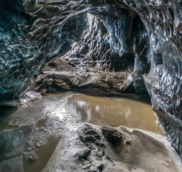 Ice cave located beneath glacier among ice mountain in Iceland it is mesmerizing landmark