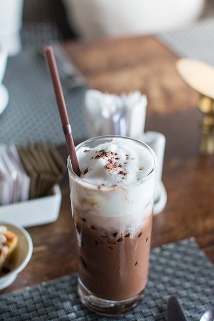 Ice chocolate with whipped cream on table