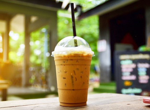 Ice coffee on wooden table in coffee shop for drink