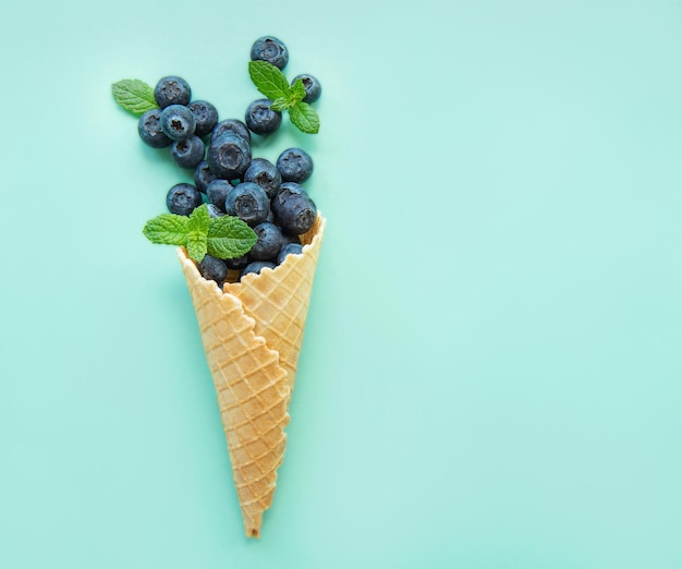 Ice cream cone filled with blueberries