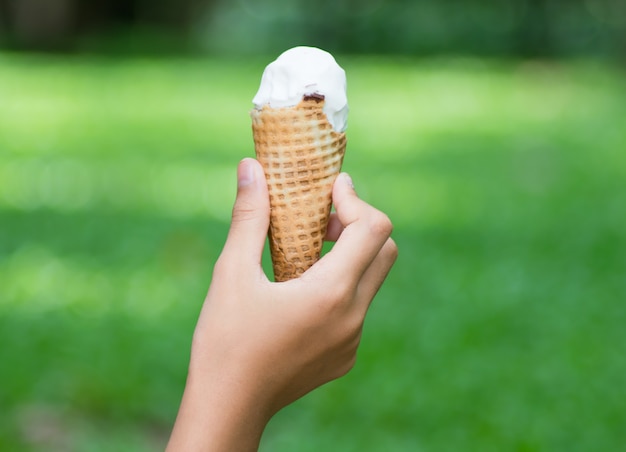 Ice cream cone on girl hand