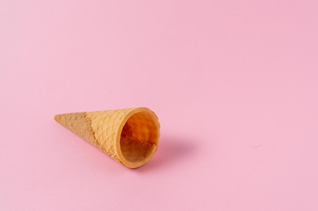 Ice cream cone on a light pink background.