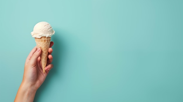 Photo ice cream in hand on blue background with copy space