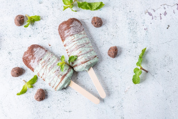 Ice cream mint chocolate chip, covered with chocolate stick. Popsicle and Lolly sweet dessert. Top view