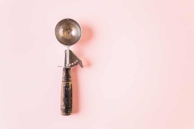 Ice cream scoop on a pink background.