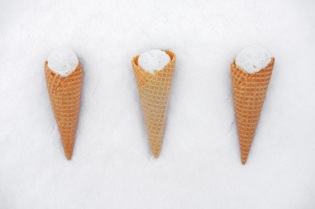 Ice cream in waffle cone in snow