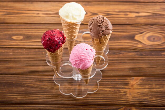 Ice cream waffle cones with berries chocolate and vanilla