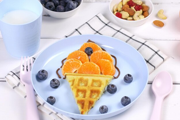 Ice cream Waffles with fruits for children's breakfast A creative idea for a fun kids dessert or breakfast