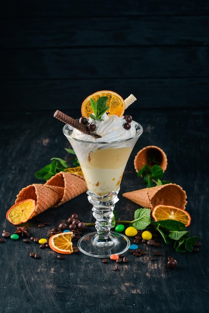 Ice Cream with Oranges On a black wooden background Copy space