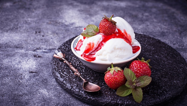 Ice cream with strawberry topping. Selective focus