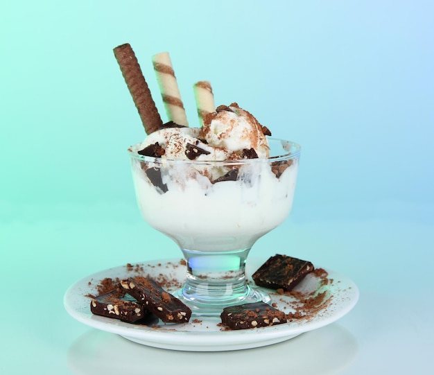 Ice cream with wafer sticks on blue background