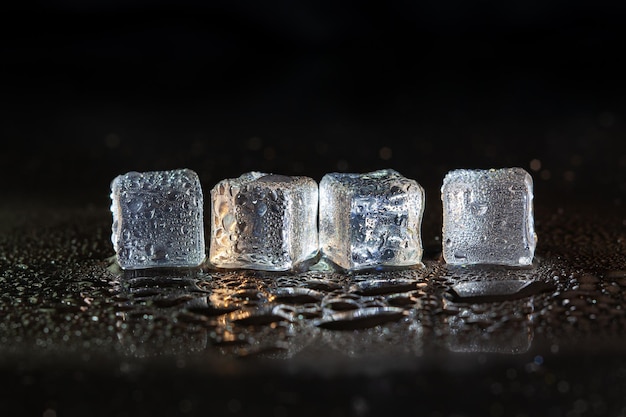 Ice cubes on black table background