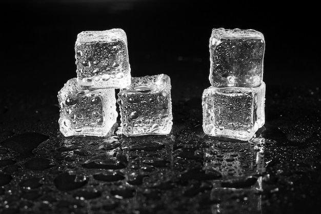 Ice cubes on black table