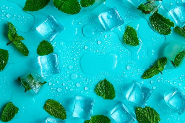 Ice cubes and mint on a blue background Selective focus