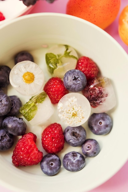 Ice cubes with berries and flowers