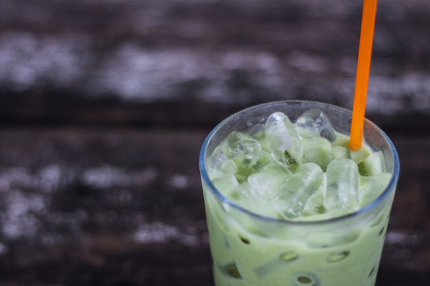 Ice green tea in glass on wood table