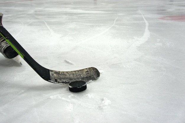 Ice hockey player in action kicking with stick