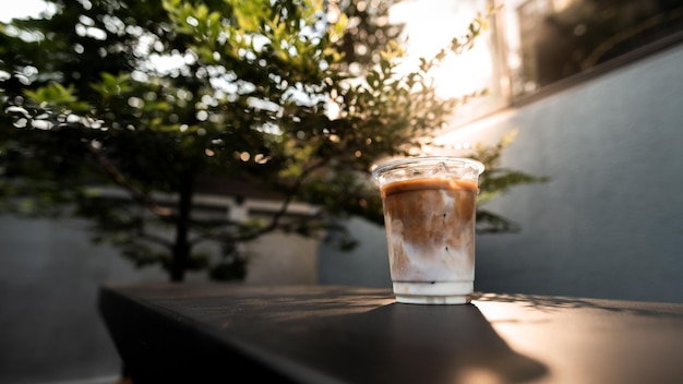 Ice latte coffee in plastic glass on black table