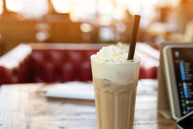 Ice mocha coffee on wooden table with smart computer pad