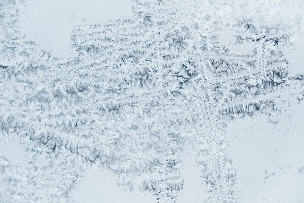 Photo ice patterns on frozen glass abstract ice pattern on winter glass as a background image