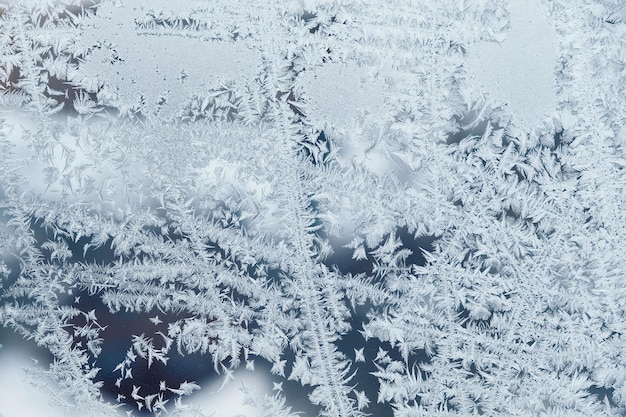 Photo ice patterns on frozen glass abstract ice pattern on winter glass as a background image