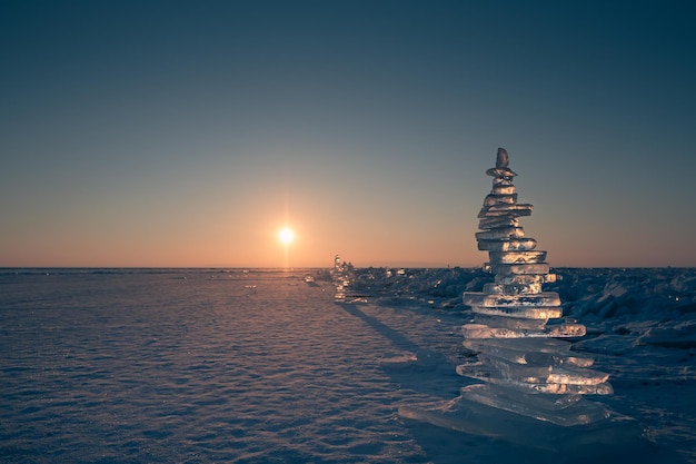 Ice pyramid on the frozen lake at sunrise Baikal lake Russia