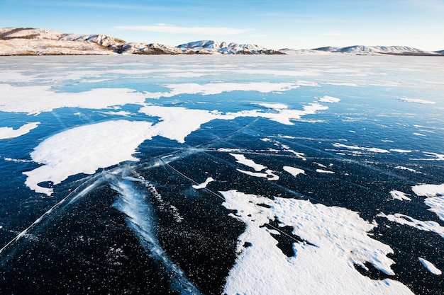 Ice and snow on the frozen lake. Beautiful winter landscape. Bannoye lake in South Ural, Russia