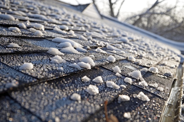 Photo ice storm damage shingle roof damage from hail balls during hailstorm