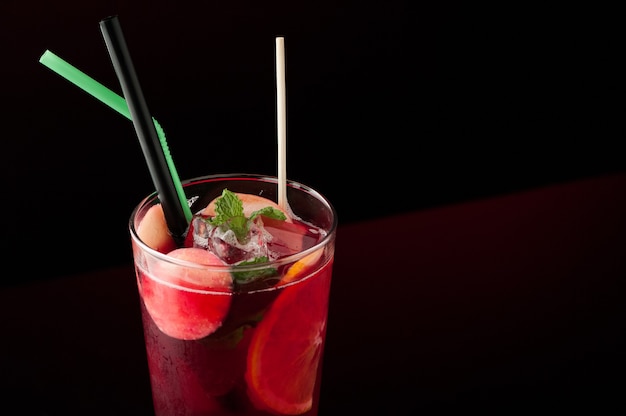 Ice tea in a glass on a dark background