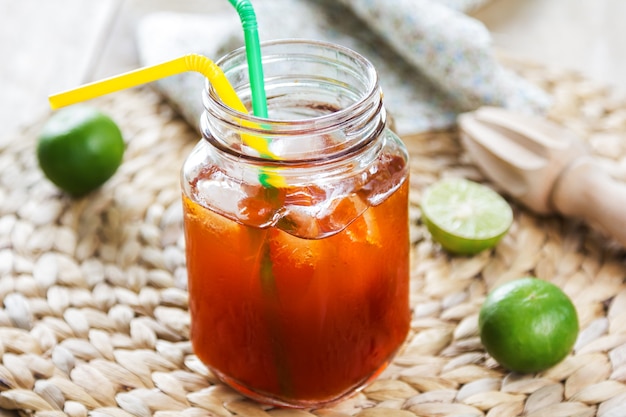 Ice tea with fresh lime by lemon reamer