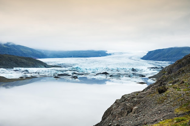 Icebergs in the glacial lake with mountain views. Vatnajokull glacier, south Iceland