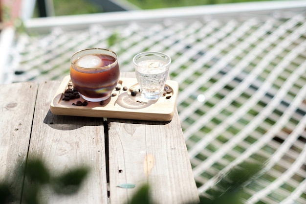 Iced Americano coffee is placed on the table in the cafe.