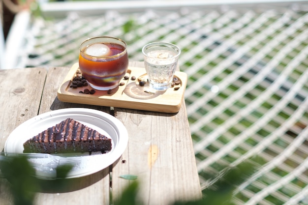 Iced Americano coffee is placed on the table in the cafe.