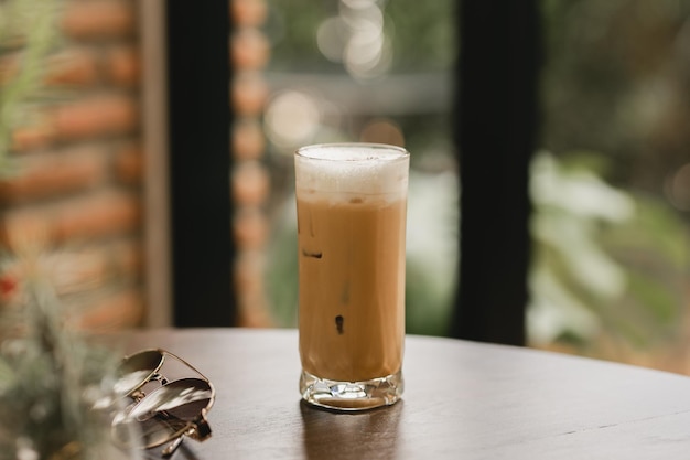 Iced cappuccino in a glass on a wooden table in the cafe