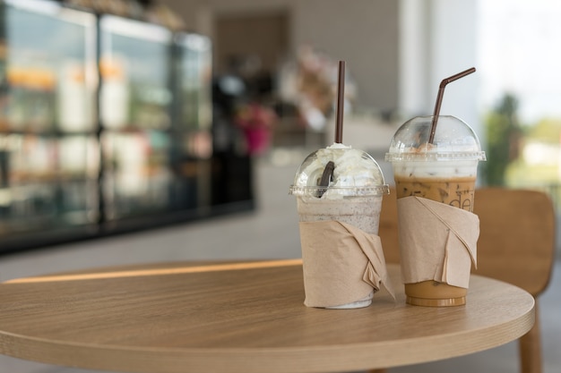 Iced Chocolate and Iced Coffee with whipped cream in cafe