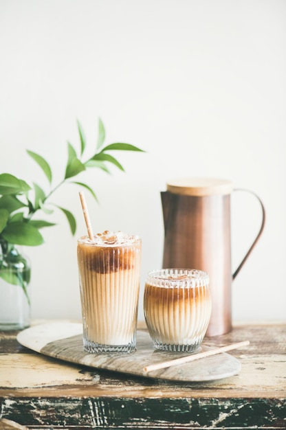 Iced coffee drink in tall glasses on wooden table