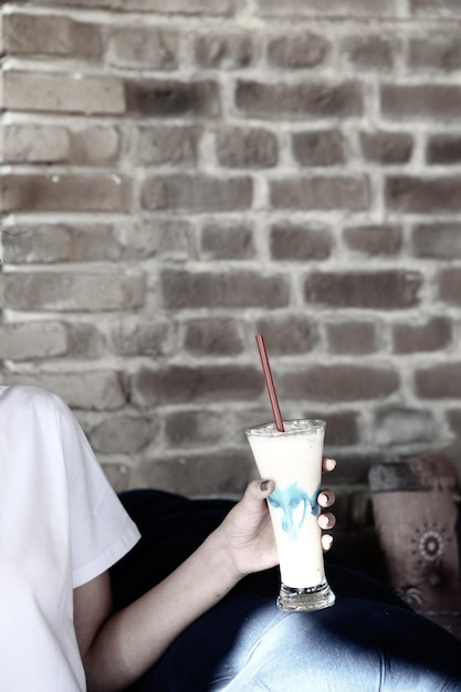 Iced coffee with milk. Iced coffee latte . Woman holding glass cup of iced coffee.