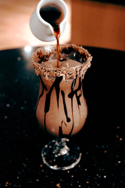 Iced coffee with milk. Iced coffee latte . Woman holding glass cup of iced coffee.