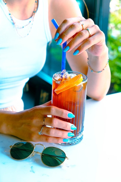 Iced coffee with milk Iced coffee latte Woman holding glass cup of iced coffee