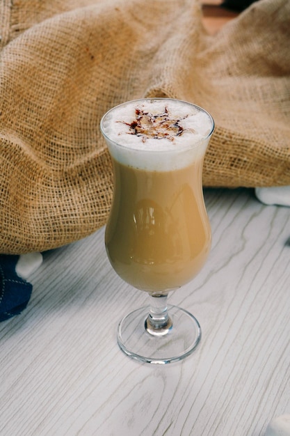 Iced coffee with milk Iced coffee latte Woman holding glass cup of iced coffee