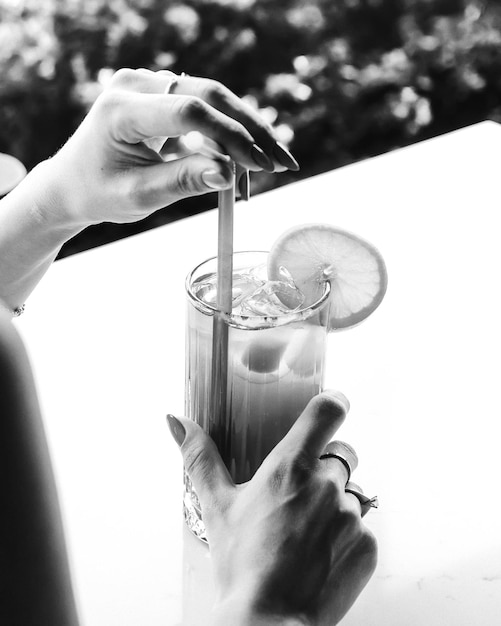 Iced coffee with milk. Iced coffee latte . Woman holding glass cup of iced coffee.