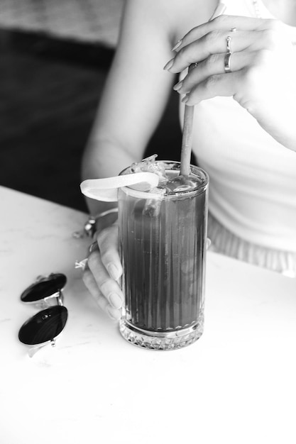 Iced coffee with milk. Iced coffee latte . Woman holding glass cup of iced coffee.