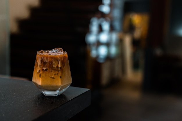 iced coffee with milk  served on the black table at a cafe