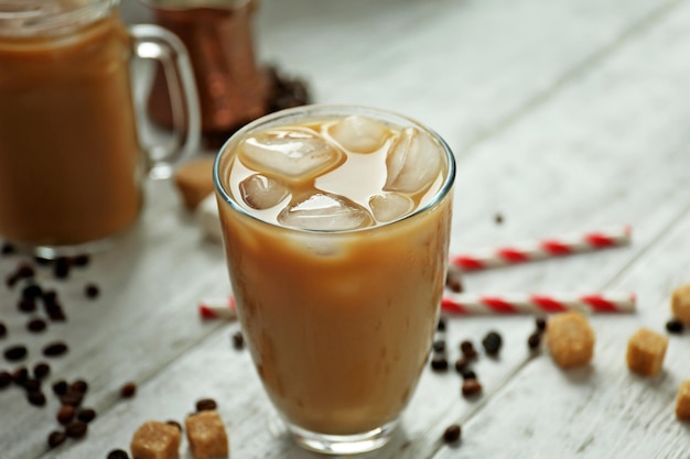 Iced coffee with milk on wooden table