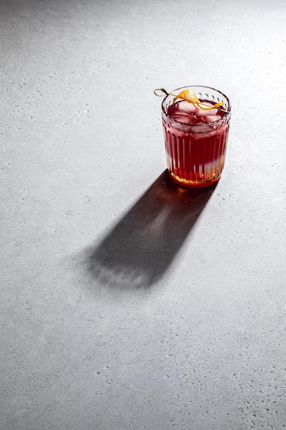 Iced cold lemonade in glass with shadow isolated on concrete tabletop